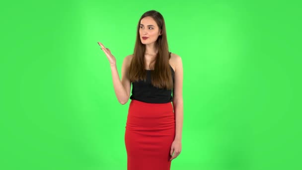 Woman pointing side hand for something then nods and shows thumb like. Green screen — Stock Video