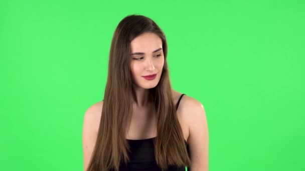 Charming girl looks around and whispers the secret and making a hush gesture. Green screen — Stock Video