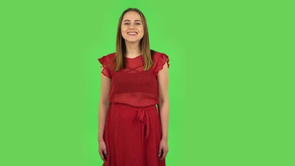 Tender girl in red dress is laughing. Green screen — ストック動画