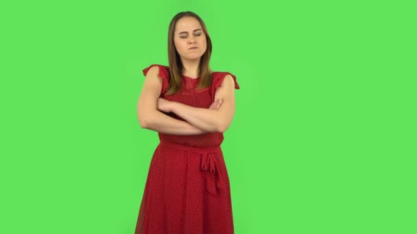 Tender girl in red dress is very offended and looking away. Green screen — Stok video