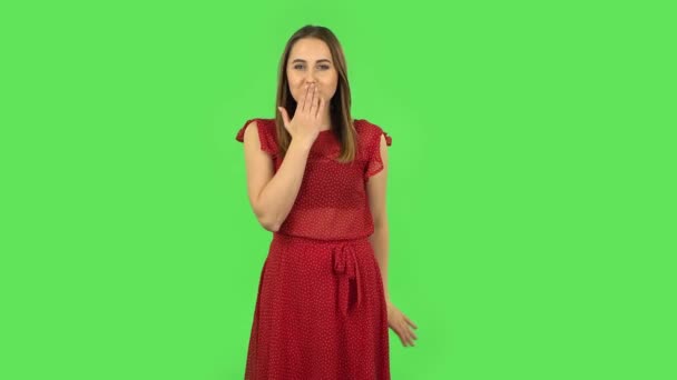 Tender girl in red dress is blowing kiss. Green screen — 图库视频影像
