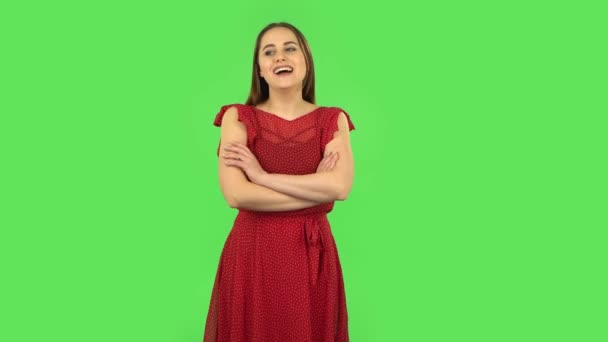Tender girl in red dress is listening to boring information and yawning. Green screen — Stock Video