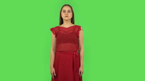 Tender girl in red dress strictly gesturing with hands crossed making X shape meaning denial saying NO. Green screen — Stock Video