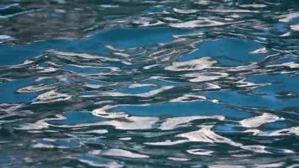 Turquoise water waves offshore with sun rays reflections. Slow motion. Close up — Stockvideo