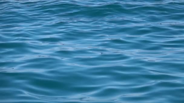 Slow motion of disturbed blue sea water surface. Close up — Stockvideo