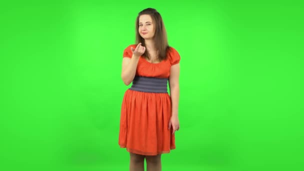 Cute girl coquettishly smiling, waving hand and showing gesture come here. Green screen — Stock Video