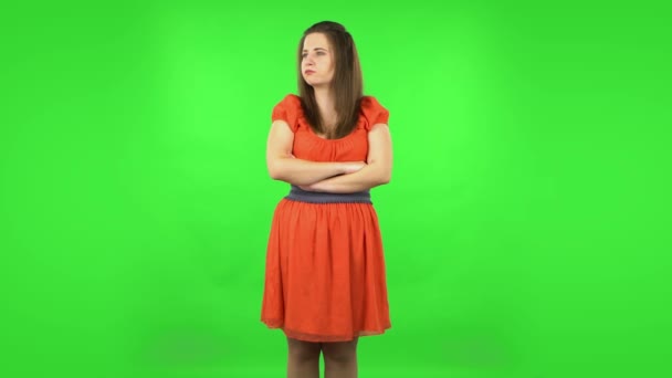Cute girl is offended and then smiling. Green screen — Stock Video