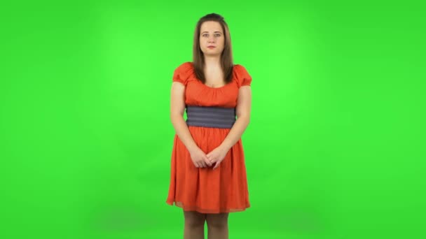 Cute girl is scared, then smiles and sighs in relief. Green screen — Stock Video