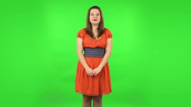 Cute girl is shocked and surprised at what is happening around, looking with delight and admiration. Green screen — Stock Video