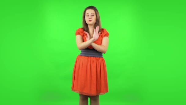 Cute girl strictly gesturing with hands crossed making X shape meaning denial saying NO. Green screen — Stock Video