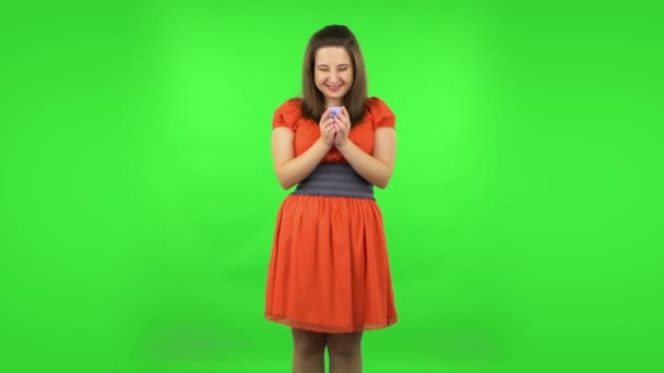 Cute girl is opening a small box with a surprise and is very disappointed with what she saw. Green screen — Stock Video