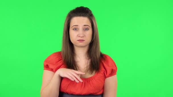 Portrait of tired girl waving hand and showing gesture come here. Green screen — Stock Video