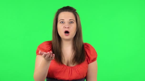 Portrait of cute girl saying Hi, showing gesture come here, covering her mouth with her hand and whispering the secret — Stock Video