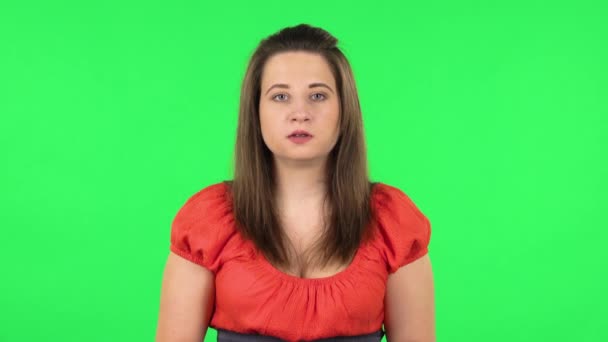 Portrait of cute girl looking at camera with anticipation, then very upset. Green screen — Stock Video