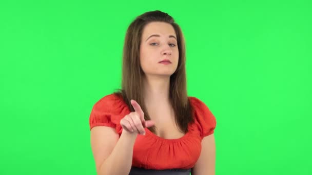 Portrait of cute girl seductively smiling and gesture threatens by shaking her index finger. Green screen — Stock Video