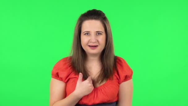 Portrait of perplexed girl in looking camera, pointing herself, say who me no thanks i do not need. Green screen — Stock Video