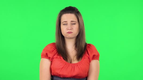 Портрет расстроенной девушки, пожимающей плечами и отрицательно покачивающей головой. Зеленый экран — стоковое видео