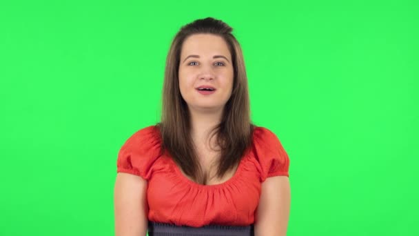 Portrait of cute girl is shocked and surprised at what is happening around, looking with delight and admiration. Green screen — Stock Video