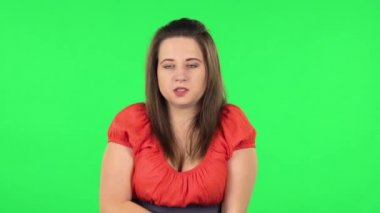 Portrait of cute girl froze and trying to keep warm. Green screen