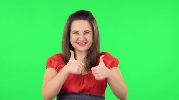 Portrait of cute girl showing thumbs up, gesture like. Green screen — Stock Video