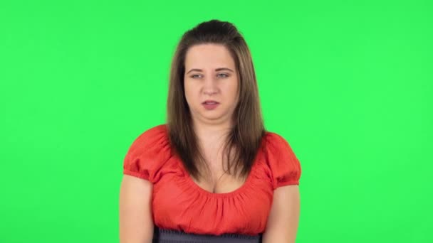 Portrait of cute girl is showing disgust for bad smell or taste. Green screen — Stock Video