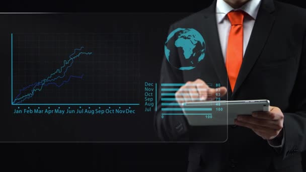 Businessman uses holographic interface, drawing an ascending financial chart. Display logistics information on a world map. Touchscreen. — Stock video