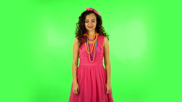 Pretty woman coquettishly smiling while looking at camera. Green screen — Stok video