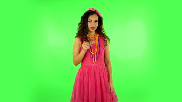 Curly girl flirts and waving hand, showing gesture come here. Green screen at studio — Αρχείο Βίντεο