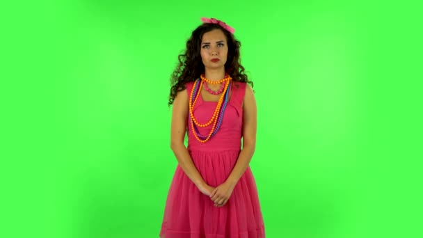 Girl says wow with smile on green screen at studio — Wideo stockowe