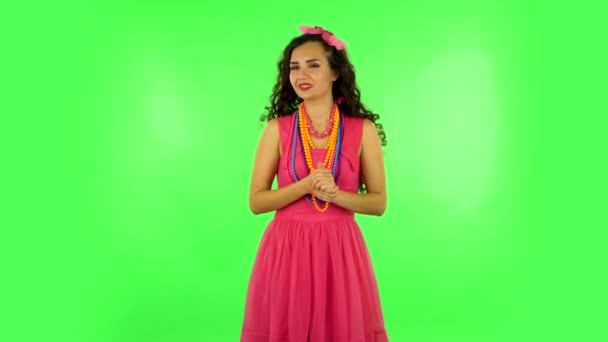 Girl looks at the camera with excitement, then sighs in relief and smiles, received pleasant information. Green screen — Stock Video