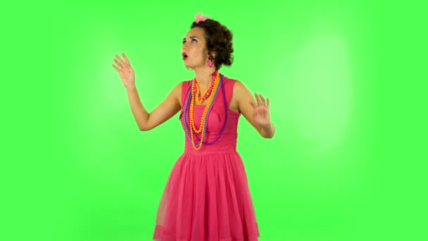 Girl is shocked and surprised at what is happening around, looking with delight and admiration. Green screen — Stock Video