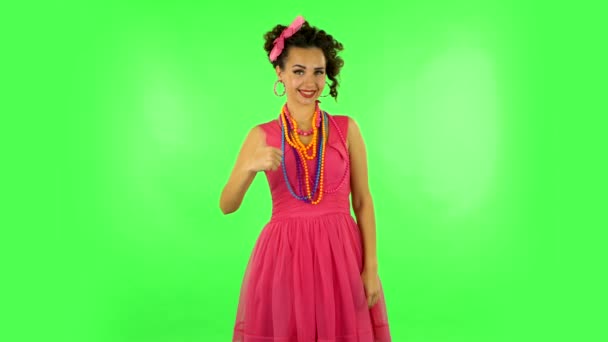 Young woman showing thumbs up gesture like, then makes sign ok and two fingers victory gesture. Green screen — Stock Video