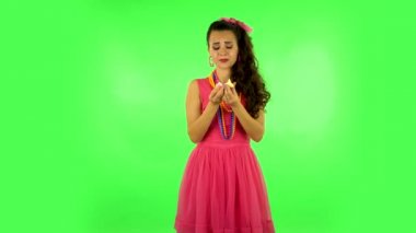 Beautiful woman wants to eat sweet white marshmallow. Green screen