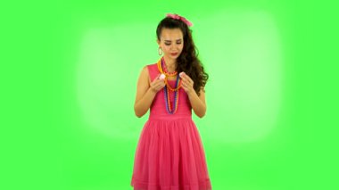 Beautiful woman with pleasure eating sweet white marshmallow, its not tasty. Green screen