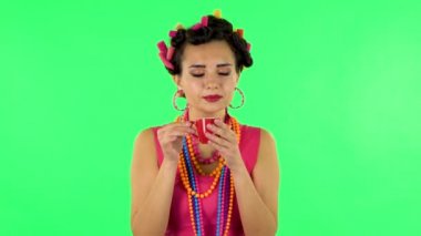 Girl drinks coffee and enjoying on green screen