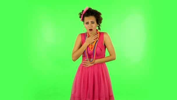 Cute female feels very bad, her stomach hurts, feeling nausea against green screen at studio. — Stock Video
