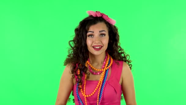 Attractive girl listens carefully then bursts into laughter. Green screen — Wideo stockowe