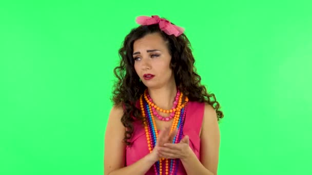 Girl claps her hands indifferently. Green screen at studio. — Stok video