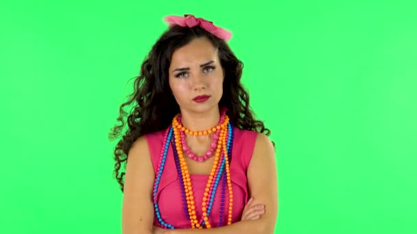 Girl listens carefully, threatens with a finger and waves her head. Green screen — Stockvideo