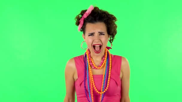 Upset girl screaming hard covering her ears with her hands. Green screen at studio — Stock Video