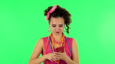 Young woman angrily texting on her phone on green screen