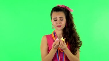 Beautiful woman wants to eat sweet white marshmallow. Green screen