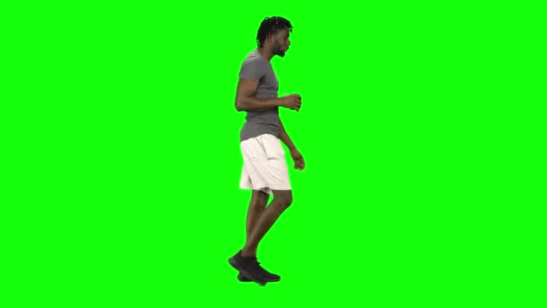 Homem afro-americano a andar e a beber café no Green Screen, Chroma Key. Vista do perfil . — Vídeo de Stock
