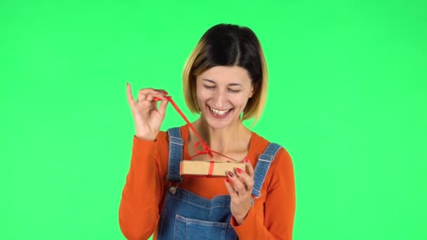Girl opens the gift, surprised and rejoices. Green screen — Stock Video