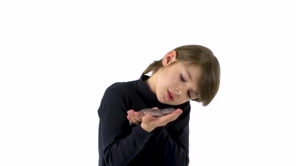 Boy is holding and carefully examines leopard eublefar at white background. Slow motion. — Stock Video