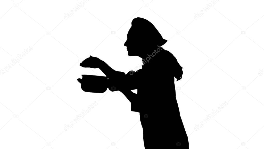 Portrait of black silhouette of a chef female in uniform smelling dish.