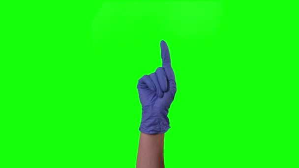 Doctors female hand in blue glove raises one index finger waving it from side to side in gesture dont do it at green screen. Close up — Stock Video