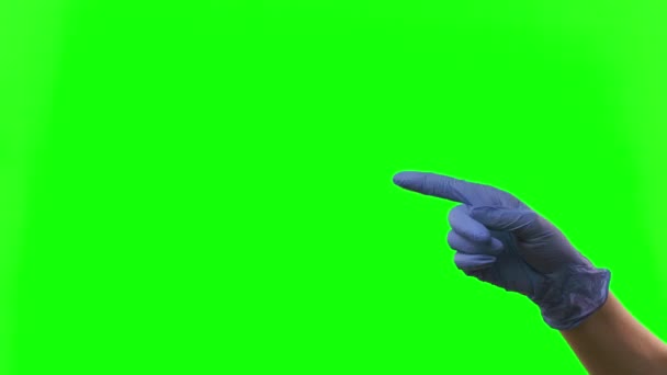 Doctors female hand in blue glove is making symbolic gestures pointing something. Green screen. Close up — Stock Video