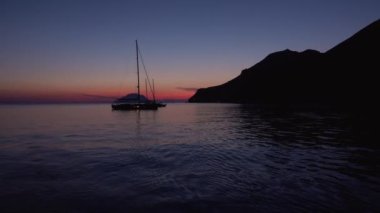 Lipari Adaları yakınlarındaki Akdeniz 'de demirli yelkenliler. Renkli gökyüzü, yaz gün batımı ya da gün doğumu. Sicilya, İtalya