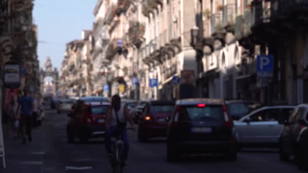 CATANIA, SICILIA, ITALIA - SEPTIEMBRE, 2019: Movimiento borroso, calle concurrida con vista a la Puerta de Giuseppe Garibaldi. Coches estacionados y en movimiento. Turistas ambulantes — Vídeo de stock